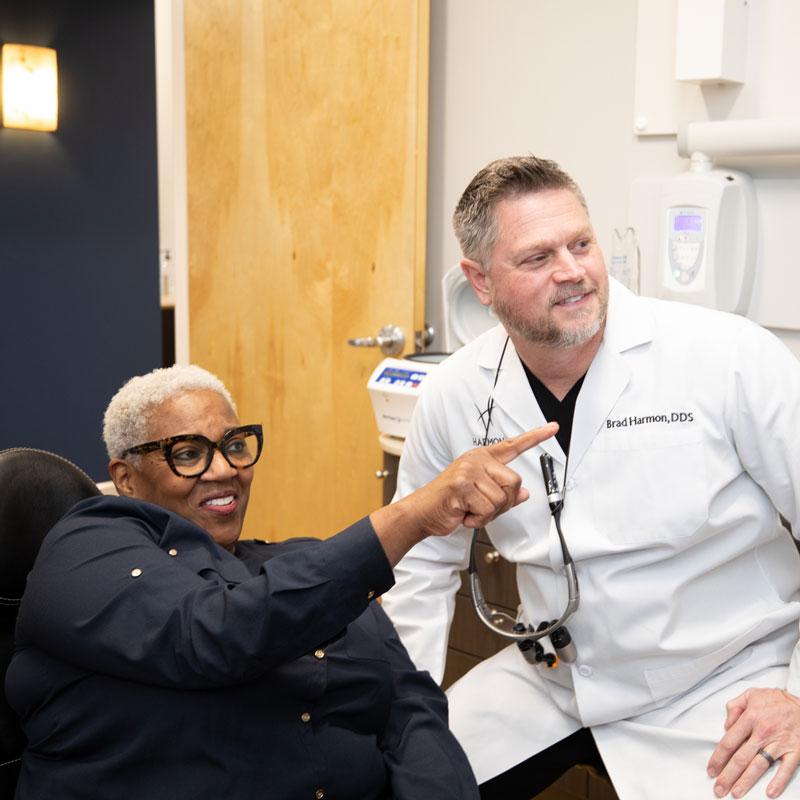 Dr. Brad Harmon Having A Personalized Consultation With A Dental Implant Patient