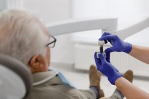 Dentist consulting patient about dental implants in modern office